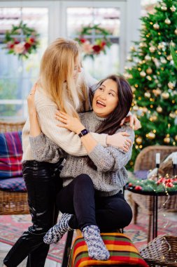 two cheerful girlfriends on New Years vacation in a country house. 