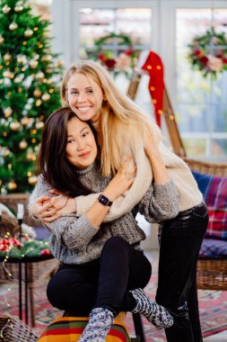 two cheerful girlfriends on New Years vacation in a country house. 