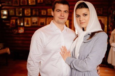 beautiful married couple in the church. Christian family religious traditions. 