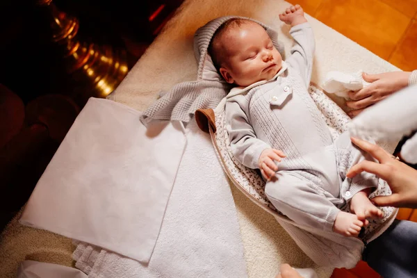 the baby dress up in clothes on the table in the Church. ordinance of baptism.