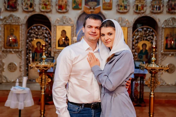 beautiful married couple in the church. Christian family religious traditions. 