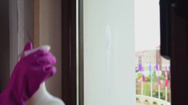 Eldivenli bir kadın camdaki bardağı yıkıyor.. 