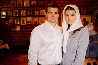 beautiful married couple in the church. Christian family religious traditions. 