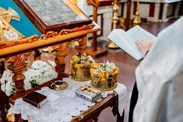 Priest is standing near Lectern.high table with sloping top for liturgical books — ストック写真