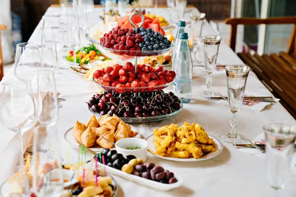 Table served with light summer snacks-fruits, vegetables, berries. — Stok fotoğraf