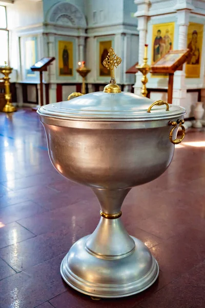 Baptismal font in Church with cover of with handle in form of Golden cross — Stock Photo, Image
