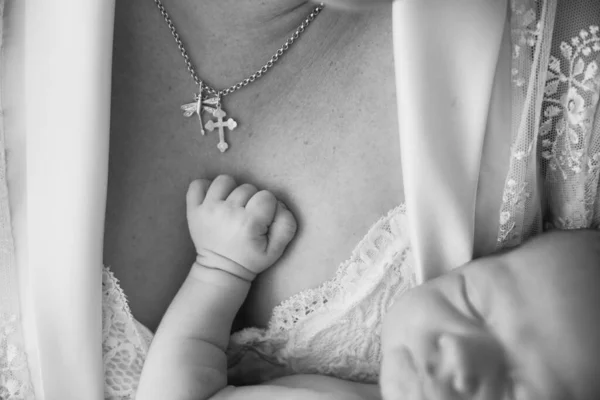 De cerca. la mano de un recién nacido durmiendo en los brazos de su madre. —  Fotos de Stock