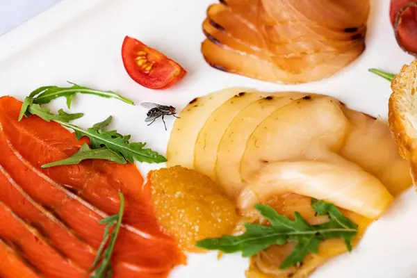 Assorted salted fish on white plate. snacks on holiday table. — Stock Photo, Image