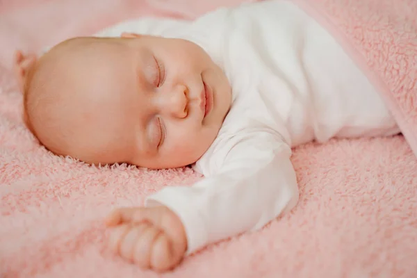 Slapende baby onder de roze deken. gezonde slaap bij pasgeborenen. — Stockfoto