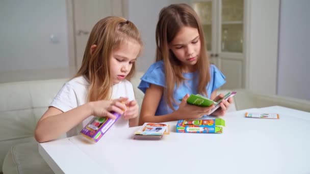 Girls unpack with new development and training cards. board games for children. — Stock Video