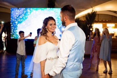 Düğün dansı. Gelin ve damat, şenlikli yemeğin sonunda misafirlerin önünde dans eder.