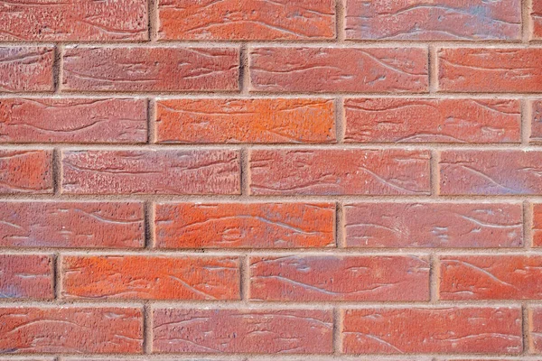Background. a wall of orange brick. Building.