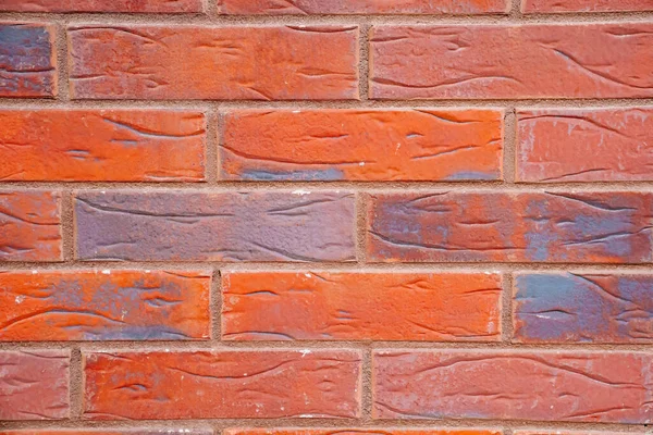 Background. a wall of orange brick. Building.