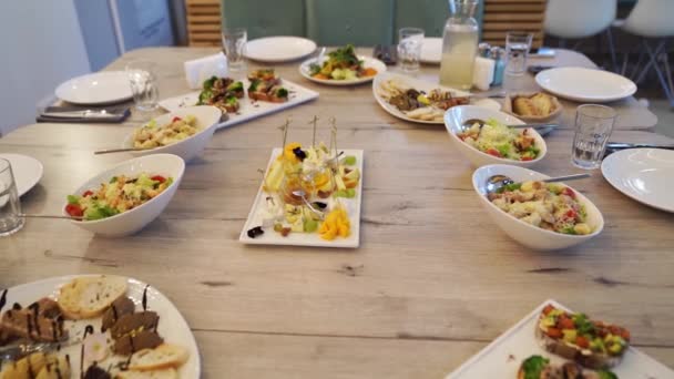 Serveert de tafel met hapjes en salades voor de vakantie. — Stockvideo