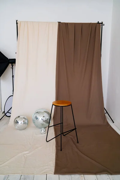 fabric on the background holder. High bar stool and mirrored disco balls.