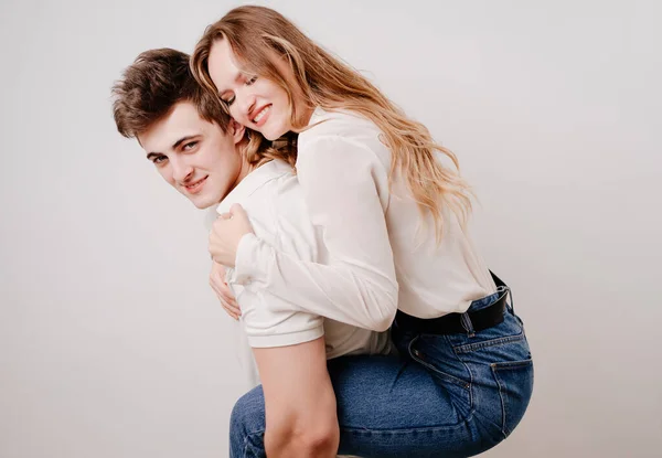 Love, passionate and beautiful couple have fun against the white wall. — Stock Photo, Image