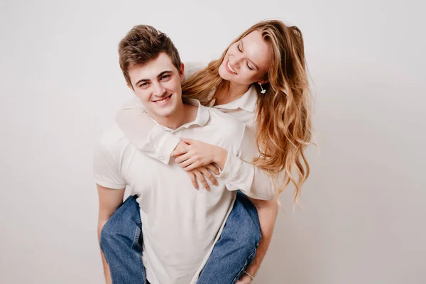 Love, passionate and beautiful couple have fun against the white wall. — Stock Photo, Image