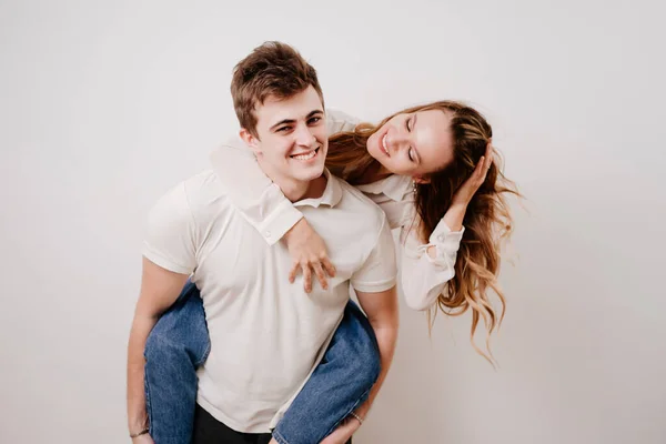 Love, passionate and beautiful couple have fun against the white wall. — Stock Photo, Image