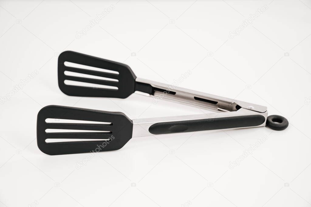 black Kitchen tongs on a white background.