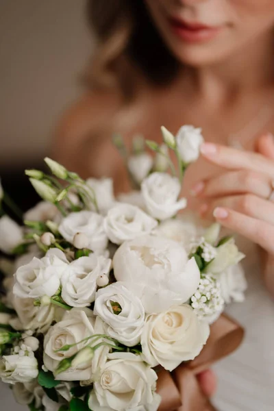 focus on flowers. bride with a bouquet. Wedding traditions.
