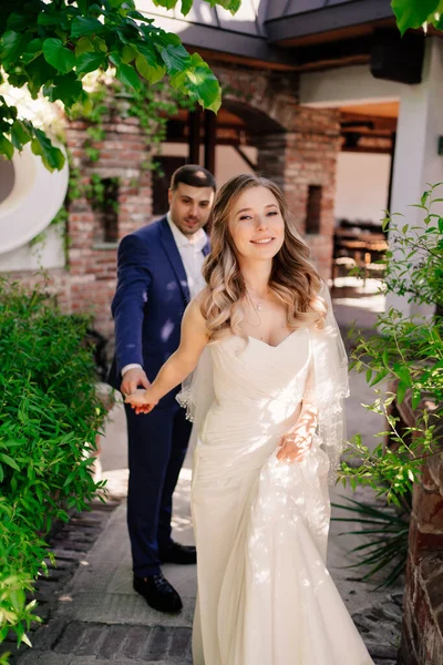 Gli sposi passeggiano nel cortile retrò del ristorante — Foto Stock