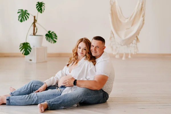 a man and a woman waiting for the birth of a child on the floor