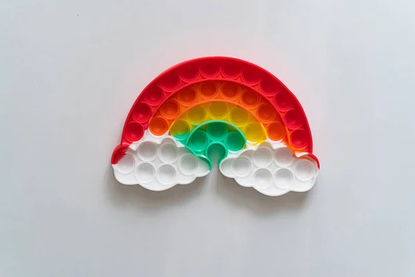 multi-colored anti-stress toy in the shape of a rainbow.