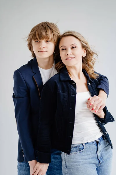 Mavi elbiseli bir anne fotoğraf çekimi için poz verir.