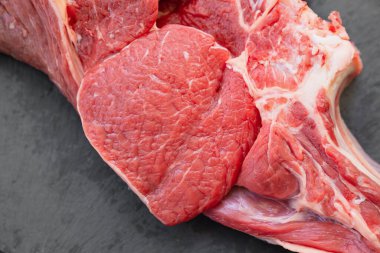 Siyah arka planda bir parça sığır eti. Doğal ve çevre dostu tarım ürünleri.