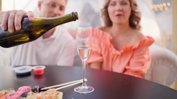 Mężczyzna nalewa szampana do szklanki na randkę. romantyczna kolacja. — Wideo stockowe