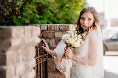 Çitte bir buket çiçekli güzel gelin..