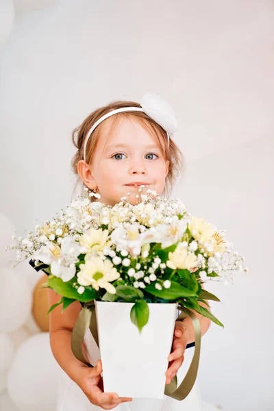 漂亮的小女孩，戴着一束花。花店. — 图库照片