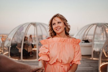 Birbirine aşık bir erkek ve bir kadın randevuda çatıdaki bir kafeye yürür..