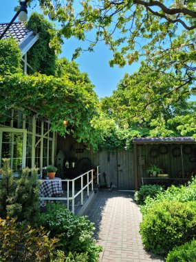 Panoramik pencereli kır evi ve bahçede öğle yemeği için bir masa..