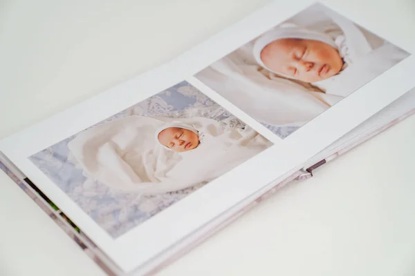on white background photobook from photo shoot with a newborn child
