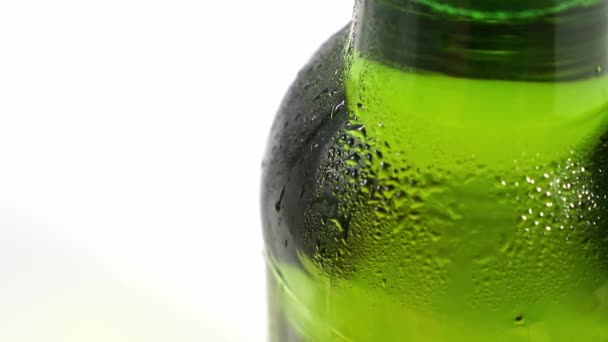 Close up. drops flow down the cold green glass of the bottle. condensate — Stock Video