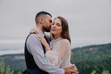 Çekici erkek ve kadın doğada şefkatle sarılıyorlar. romantizm ilişkisi