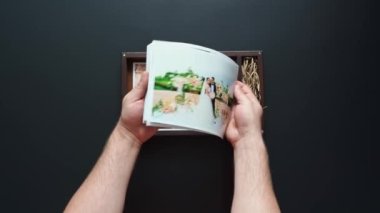 Fotoğrafçı düğün fotoğraflarını ve flaş belleği bir kutuya koyar.. 