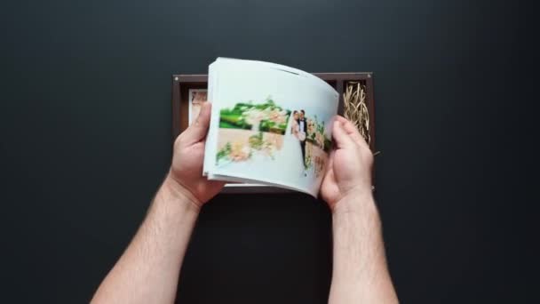 Le photographe met des photos de mariage et une clé USB dans une boîte. — Video