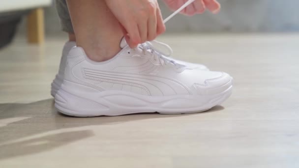 Legare i lacci sulle scarpe da ginnastica bianche donne mani primo piano. sport, corsa — Video Stock