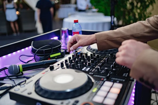 DJs hands on music equipment. Mixers, turntables, switching, acoustics.