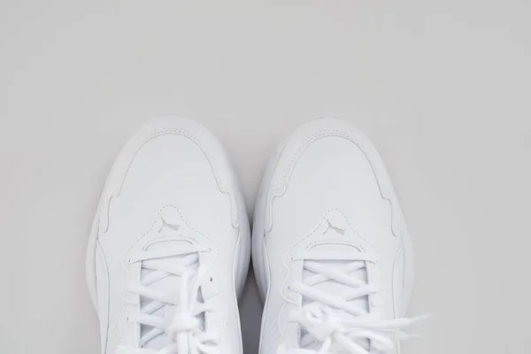 Puma. baskets blanches avec des lacets sur fond blanc. isoler. vue de dessus. — Photo