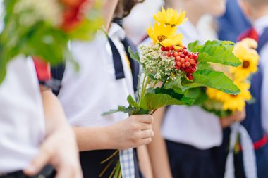 Çocukların elinde bir sonbahar buketi var. bilgi bayramı.