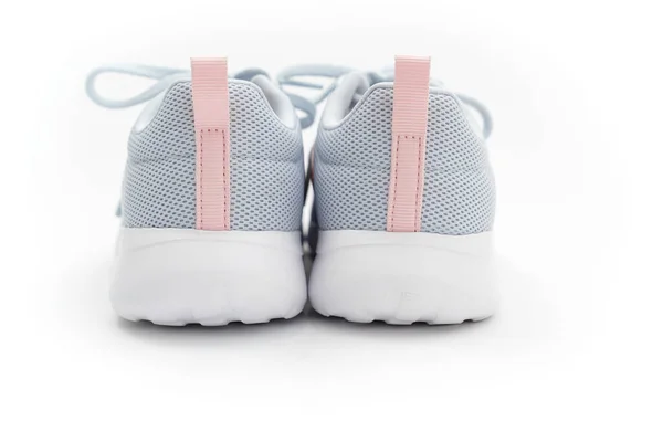 Del av grå sportskor med rosa ränder på en vit bakgrund. adidas — Stockfoto