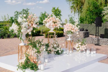 Çiçeklerin açık havasında, mumlarla birlikte düğün töreni.