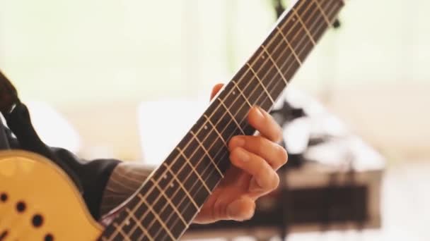 Man plays strings of guitar. learning to play musical stringed instruments. — Stock Video