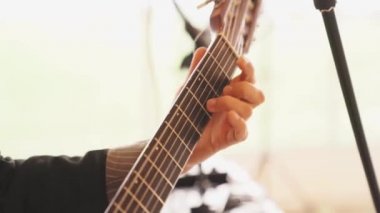 Adam gitar telleri çalıyor. müzik telli enstrüman çalmayı öğrenmek.