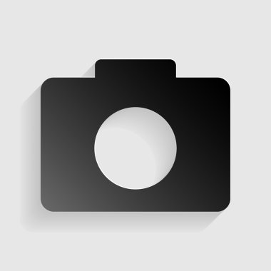 Dijital kamera işareti. Gri arka planda gölgesi olan siyah kağıt.