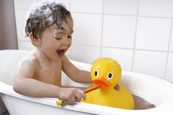 Cute toddler playing in a bathtub — Stock Photo, Image