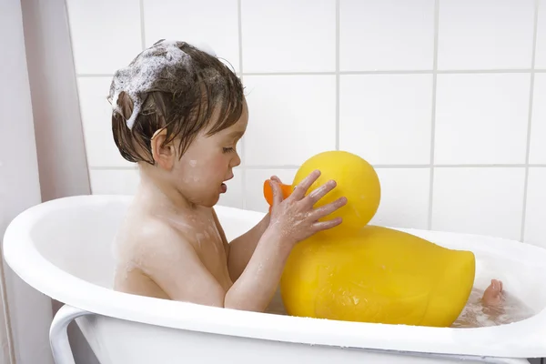 Cute toddler playing in a bathtub — Stock Photo, Image